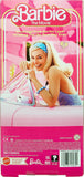 Barbie The Movie Doll Wearing Pink and White Gingham Dress with Daisy Chain Necklace for Ages 3 Years and Up